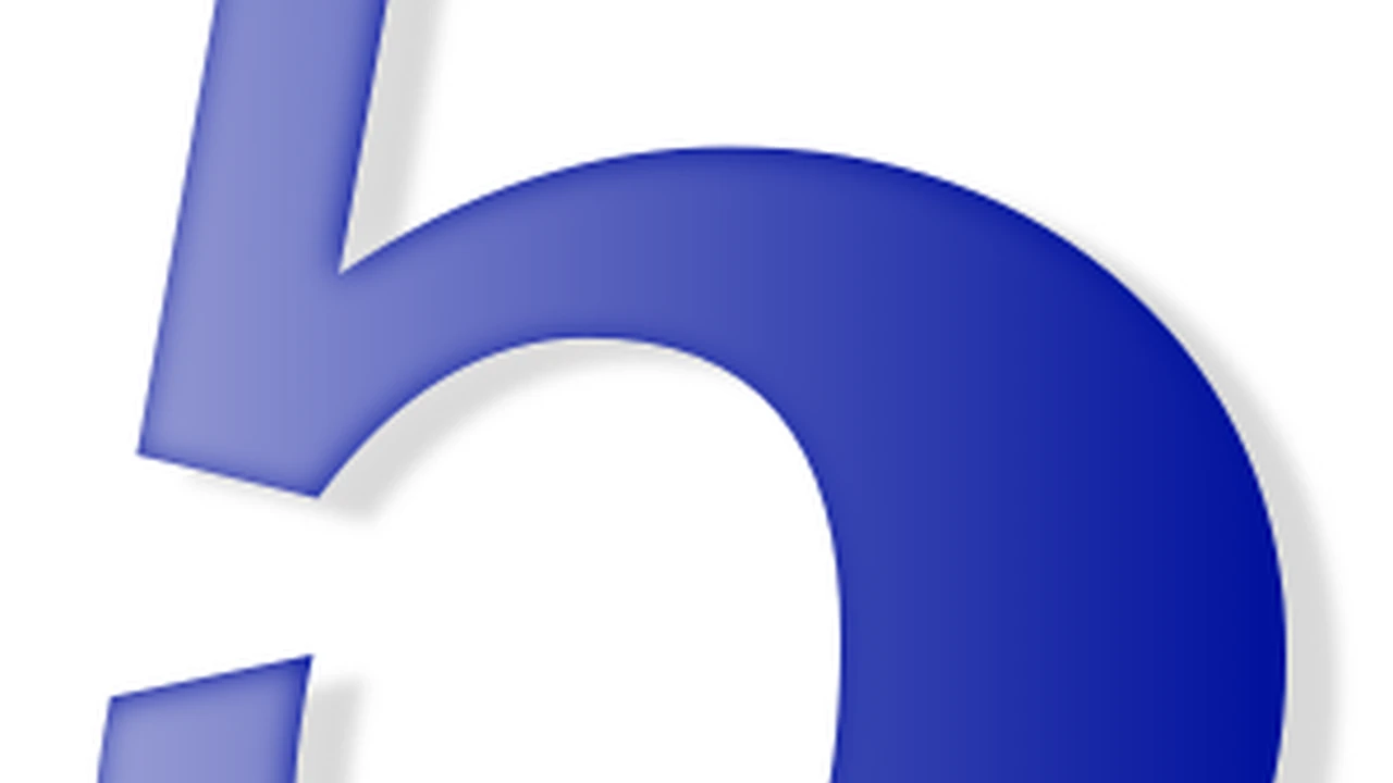 overhead view of corned beef sliced and on a platter with cabbage, potatoes, and carrots