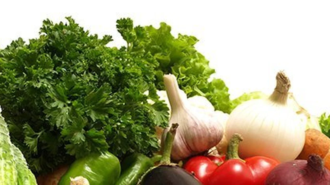 overhead view of corned beef sliced and on a platter with cabbage, potatoes, and carrots