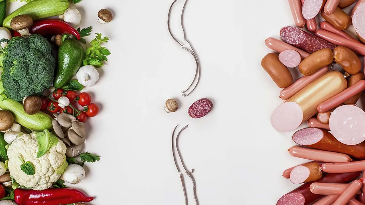 Two mint chocolate milkshakes with whipped cream and green sprinkles.
