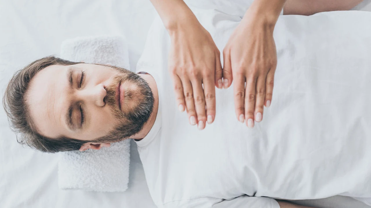 blue bowl of black bean beef tortilla soup on a board with cilantro and shredded cheese in background
