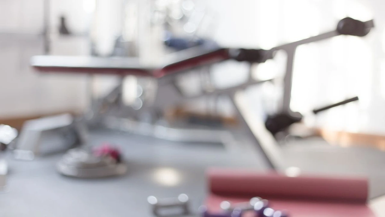 blue bowl of black bean beef tortilla soup on a board with cilantro and shredded cheese in background
