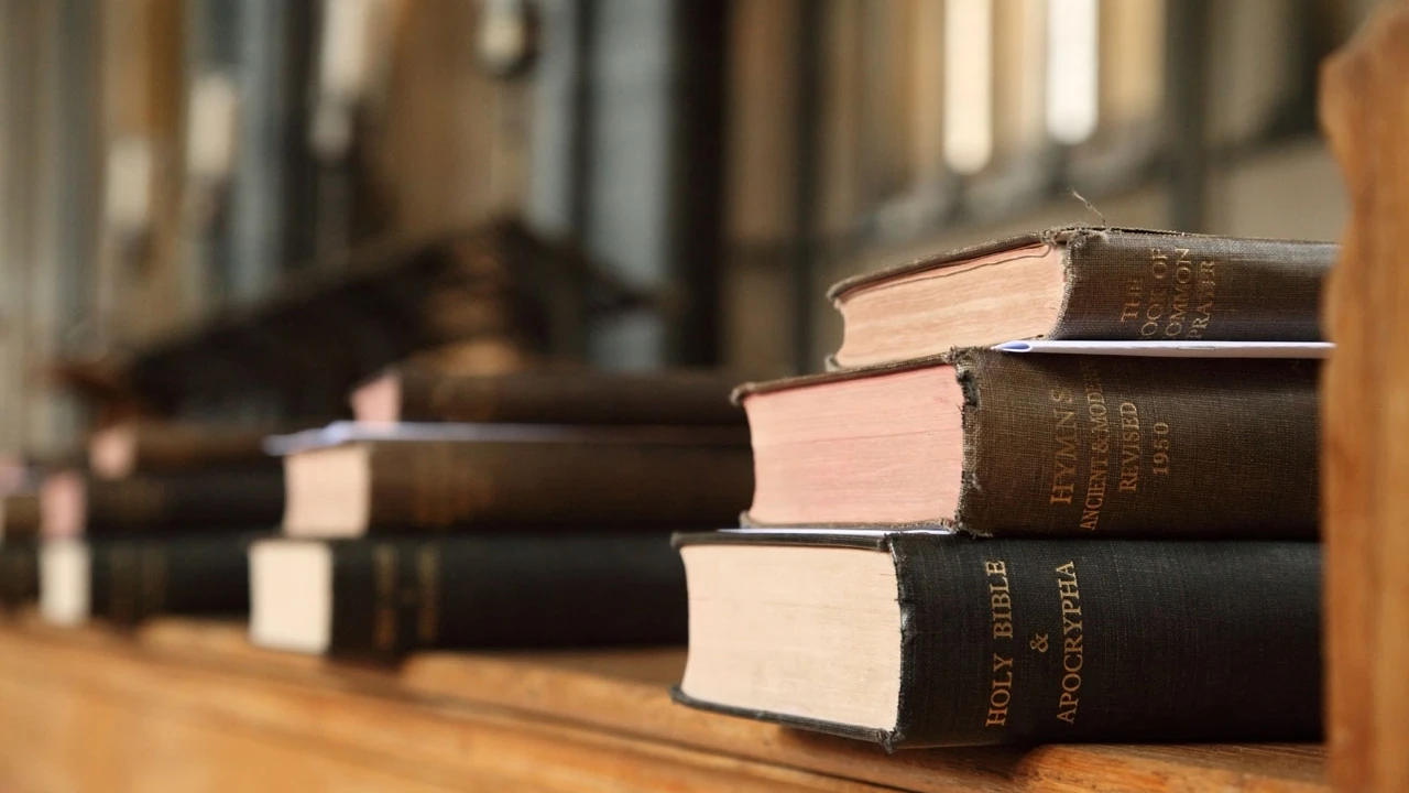 Close up on a plate of mashed potatoes, topped with baked pork chops with cream of mushroom soup, and a side of green beans.