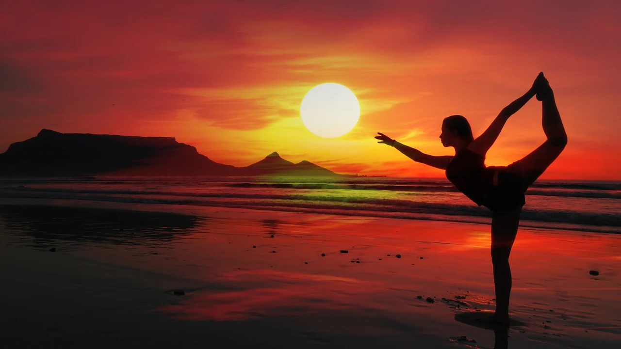 blue bowl of black bean beef tortilla soup on a board with cilantro and shredded cheese in background